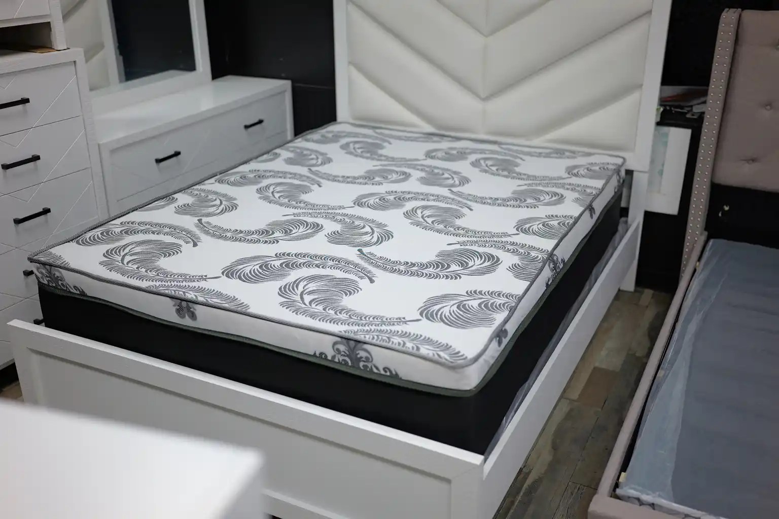 Premium mattress with paisley pattern on an upholstered bed frame